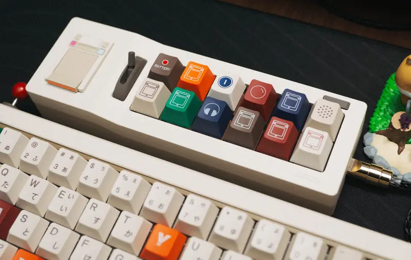 Close-up of a colorful retro mechanical keyboard with custom keycaps on a dark desk
