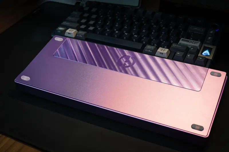A stylish mechanical keyboard showcasing a vibrant pink and purple design, perfect for tech enthusiasts