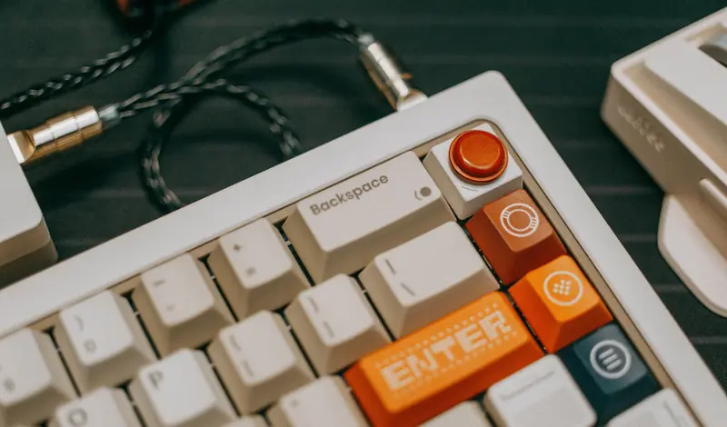Detailed view of a mechanical keyboard with colorful keys and cable connection, showcasing modern design