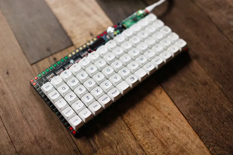 White mechanical keyboard with RGB lights on a rustic wooden surface, emphasizing technology and design