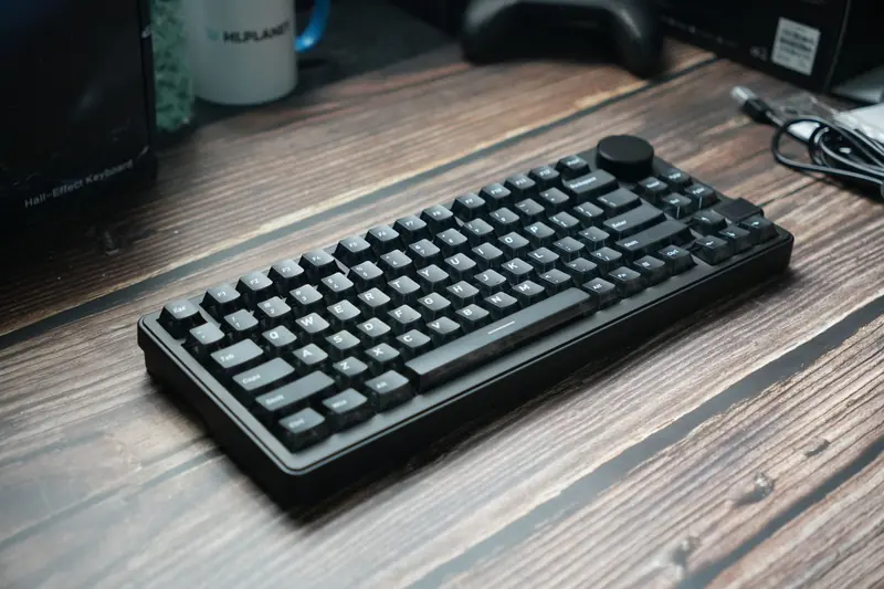 A sleek black mechanical keyboard placed on a wooden desk, ideal for gaming or office use